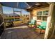 Relaxing screened patio with pond view, featuring tiled floor and comfortable seating at 1506 Bentwood Dr, Sun City Center, FL 33573