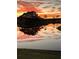 Magnificent sunset reflecting on the pond, creating a peaceful and scenic community ambiance at 1506 Bentwood Dr, Sun City Center, FL 33573