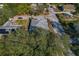 Aerial view of a single-story house with a gray roof and a small yard at 1509 E Tessier Dr, Tarpon Springs, FL 34689