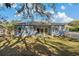 View of home's back patio and backyard at 1509 E Tessier Dr, Tarpon Springs, FL 34689