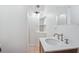 Clean bathroom with a single sink vanity, shower, and built-in shelving at 1514 Nelson Ave, Clearwater, FL 33755