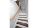 Wooden staircase with dark stained treads and white risers at 1535 Manor S Way, St Petersburg, FL 33705