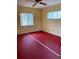 A bedroom featuring painted yellow walls, pinkish-red flooring, and a ceiling fan at 1660 S Lake Ave # 1, Clearwater, FL 33756