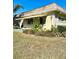 Exterior view of the house showing a yellow building with a brown roof at 1660 S Lake Ave # 1, Clearwater, FL 33756