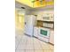 Galley kitchen with white cabinets, tile floors and modern appliances at 1660 S Lake Ave # 1, Clearwater, FL 33756