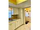 White kitchen cabinets, tile flooring, and view into the entryway at 1660 S Lake Ave # 1, Clearwater, FL 33756