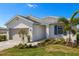 Charming single-story home featuring a well-manicured lawn and neutral-toned exterior at 17901 Solstice Ave, Venice, FL 34293