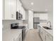 Contemporary kitchen with white cabinetry, stainless steel appliances, and recessed lighting at 17901 Solstice Ave, Venice, FL 34293