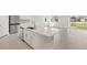 Bright kitchen with white cabinets, stainless steel appliances, and an island at 17901 Solstice Ave, Venice, FL 34293