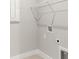 Efficient laundry area with tile flooring and wire shelving for optimal organization at 17901 Solstice Ave, Venice, FL 34293