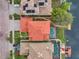 Directly above a home showcasing the roofline, pool, and canal at 18014 Cozumel Isle Dr, Tampa, FL 33647