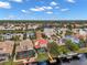 Aerial view of a luxury waterfront community with many homes and a lake at 18014 Cozumel Isle Dr, Tampa, FL 33647