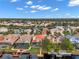 Aerial view of a waterfront community with houses, pools, and docks at 18014 Cozumel Isle Dr, Tampa, FL 33647