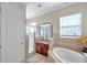 Elegant bathroom with soaking tub, walk-in shower, and granite vanity at 18014 Cozumel Isle Dr, Tampa, FL 33647