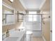 Updated bathroom with a shower/tub combo, a vanity with a white countertop, and neutral-toned tile floors at 18014 Cozumel Isle Dr, Tampa, FL 33647