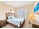Bright bedroom with a wooden bed frame and large window at 18014 Cozumel Isle Dr, Tampa, FL 33647