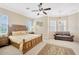 Large bedroom with a king-size bed, ceiling fan, and plenty of windows at 18014 Cozumel Isle Dr, Tampa, FL 33647