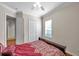 Spacious bedroom with double bed, hardwood floors, and access to hallway at 18014 Cozumel Isle Dr, Tampa, FL 33647