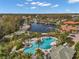 Aerial view of resort-style pool with lake and community features at 18014 Cozumel Isle Dr, Tampa, FL 33647