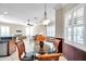 Casual dining area with glass table, four chairs, and view into living room at 18014 Cozumel Isle Dr, Tampa, FL 33647