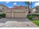 Two-story house with a two-car garage and a brick driveway at 18014 Cozumel Isle Dr, Tampa, FL 33647