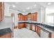 Kitchen with stainless steel appliances and dark wood cabinets at 18014 Cozumel Isle Dr, Tampa, FL 33647