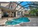 Kidney-shaped pool with a screened enclosure at 18014 Cozumel Isle Dr, Tampa, FL 33647