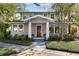 Charming two-story home with a red door and landscaped yard at 2110 W Southview Ave, Tampa, FL 33606