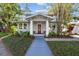 Two story craftsman home with a red door and walkway at 2110 W Southview Ave, Tampa, FL 33606