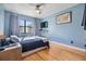 Cozy bedroom with hardwood floors and a view of nature at 215 Woods Landing Trl, Oldsmar, FL 34677