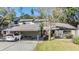 Townhouse with carport, landscaping, and a tranquil setting at 215 Woods Landing Trl, Oldsmar, FL 34677