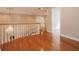 Upper hallway with hardwood floors and chandelier at 2817 Roehampton Close, Tarpon Springs, FL 34688