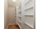 Walk-in pantry with ample shelving for storage at 2817 Roehampton Close, Tarpon Springs, FL 34688