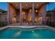 Inviting pool and patio with brick columns, illuminated at night at 2817 Roehampton Close, Tarpon Springs, FL 34688