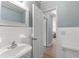 Bathroom with pedestal sink and view to hallway at 3315 58Th S Ave # 210, St Petersburg, FL 33712