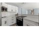 Modern kitchen with white cabinets and stainless steel appliances at 3315 58Th S Ave # 210, St Petersburg, FL 33712