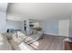 Open concept living room with L-shaped sofa and modern kitchen at 3315 58Th S Ave # 210, St Petersburg, FL 33712