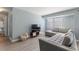 Bright living room featuring a sectional sofa, large TV, and hardwood floors at 3315 58Th S Ave # 210, St Petersburg, FL 33712
