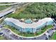 Aerial view of a blue building with a pool and surrounding nature at 3315 58Th S Ave # 513, St Petersburg, FL 33712