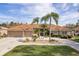 Front exterior of home with two-car garage and lush landscaping at 3337 Crescent Oaks Blvd, Tarpon Springs, FL 34688