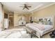 Spacious main bedroom with a large bed and sitting area at 3337 Crescent Oaks Blvd, Tarpon Springs, FL 34688