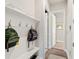 Inviting mudroom with bench, hooks, and shelving for storage at 3957 Epic Cv, Land O Lakes, FL 34638