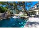 Backyard pool with a slide, a hot tub, lounge chairs in the pool and a fire pit at 4518 W Rosemere Rd, Tampa, FL 33609