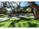 Expansive backyard with putting green, firepit and mature trees providing shade for relaxing and entertaining at 4518 W Rosemere Rd, Tampa, FL 33609