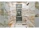 Stunning bathroom showcases luxurious marble tiles, glass shower, and elegant fixtures, providing a spa-like experience at 4518 W Rosemere Rd, Tampa, FL 33609