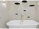 Freestanding tub with gold hardware and minimalist design, illuminated by modern lighting at 4518 W Rosemere Rd, Tampa, FL 33609