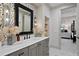 Beautiful bathroom featuring patterned accent wall, vessel sink, and modern finishes, offering a serene retreat at 4518 W Rosemere Rd, Tampa, FL 33609