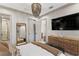 Spacious bedroom with a large window, a chandelier, and a decorative dresser at 4518 W Rosemere Rd, Tampa, FL 33609
