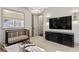 Bright bedroom featuring crib, modern dresser, and stylish light fixtures at 4518 W Rosemere Rd, Tampa, FL 33609
