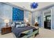 Bedroom with artistic wall decor, modern lamps, and en suite bathroom access at 4518 W Rosemere Rd, Tampa, FL 33609